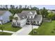 Well-maintained home with manicured lawn, two palm trees, and a red front door at 626 Chigwell Springs Ln, Summerville, SC 29486