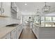 Modern kitchen features white cabinetry, stainless appliances, and view into dining area at 626 Chigwell Springs Ln, Summerville, SC 29486
