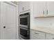 Modern kitchen features stainless steel double ovens and white cabinetry at 626 Chigwell Springs Ln, Summerville, SC 29486