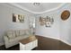 Open-concept living room with hardwood floors, decor, and a glimpse into the bright, modern kitchen at 626 Chigwell Springs Ln, Summerville, SC 29486