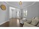 Inviting living room with tray ceiling, hardwood floors, and large windows offering lots of natural light at 626 Chigwell Springs Ln, Summerville, SC 29486