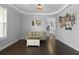 Bright living room with hardwood floors, tray ceiling, open layout and backyard view at 626 Chigwell Springs Ln, Summerville, SC 29486
