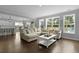 Bright and airy living room featuring hardwood floors, large windows, and open floor plan at 626 Chigwell Springs Ln, Summerville, SC 29486