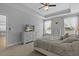 Spacious main bedroom features a ceiling fan, large dresser with TV, and natural light at 626 Chigwell Springs Ln, Summerville, SC 29486