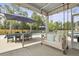 Inviting screened patio boasts a swing, dining, and a pool, perfect for relaxing and entertaining outdoors at 626 Chigwell Springs Ln, Summerville, SC 29486