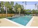 Beautiful pool with waterfall feature and palm trees, complemented by comfortable lounge chairs for relaxation at 626 Chigwell Springs Ln, Summerville, SC 29486