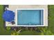 Top-down shot of rectangular pool with lounge area, umbrella, tasteful landscaping and lush lawn at 626 Chigwell Springs Ln, Summerville, SC 29486
