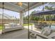 Covered porch features a swing and table with lush landscaping and swimming pool at 626 Chigwell Springs Ln, Summerville, SC 29486