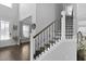 Grand foyer features hardwood floors, a staircase with iron spindles, and an elegant, neutral color palette at 626 Chigwell Springs Ln, Summerville, SC 29486