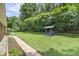Expansive backyard with lush lawn and swing set, perfect for outdoor activities and leisure at 6305 Lucille Dr, North Charleston, SC 29406
