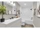 Bright bathroom boasts modern white vanity, black fixtures, and a bathtub with shower at 6305 Lucille Dr, North Charleston, SC 29406