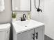Updated vanity and sink with black faucet and a potted plant in a modern bathroom at 6305 Lucille Dr, North Charleston, SC 29406