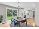 Dining area with an adjacent modern kitchen, an abundance of natural light, and backyard views at 6305 Lucille Dr, North Charleston, SC 29406
