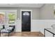 Inviting entryway with paneled wainscoting, a black front door, and a window with a view at 6305 Lucille Dr, North Charleston, SC 29406