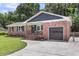 Charming brick home with an attached garage, well-manicured lawn, and inviting curb appeal at 6305 Lucille Dr, North Charleston, SC 29406