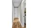 Bright hallway with hardwood floors and white trim, leading to various rooms in the home at 6305 Lucille Dr, North Charleston, SC 29406
