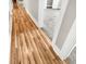 Hallway featuring wood floors transitions into carpeted rooms, creating a seamless flow at 6305 Lucille Dr, North Charleston, SC 29406