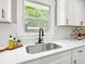 Close-up of a kitchen sink and window, highlighting the modern fixtures and finishes at 6305 Lucille Dr, North Charleston, SC 29406