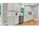 Well-lit kitchen boasts stainless steel appliances, quartz countertops, and modern hardware at 6305 Lucille Dr, North Charleston, SC 29406