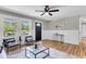 Bright living room featuring stylish seating, natural light, and a black front door at 6305 Lucille Dr, North Charleston, SC 29406