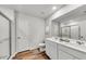 Bright bathroom featuring double sinks, white cabinets, and a glass-enclosed shower at 725 Meadowbrook Ln, Summerville, SC 29486