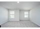 Bright, carpeted bedroom with two windows offering natural light and a view of the outside at 725 Meadowbrook Ln, Summerville, SC 29486