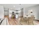 Open-concept kitchen and dining area with a center island, stainless steel appliances, and natural light at 725 Meadowbrook Ln, Summerville, SC 29486