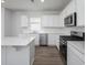 Well-equipped kitchen with stainless steel appliances, a center island, and bright, white countertops at 725 Meadowbrook Ln, Summerville, SC 29486