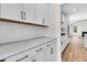 Kitchen featuring white cabinets, subway tile backsplash, and modern appliances at 735 Maynard Ln, Summerville, SC 29486