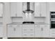 Bright kitchen featuring white cabinets, modern stainless range hood, and an open design at 735 Maynard Ln, Summerville, SC 29486