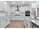 Well-lit kitchen featuring white cabinets, stainless appliances, and a farmhouse sink at 735 Maynard Ln, Summerville, SC 29486