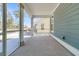 Screened in porch with concrete floor and view of adjacent house at 735 Maynard Ln, Summerville, SC 29486