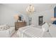 Bright main bedroom features a decorative chandelier, dresser, and inviting queen sized bed at 753 Meadowbrook Ln, Summerville, SC 29486