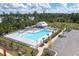 A large community pool with plenty of lounge chairs and a covered pavilion, surrounded by trees at 755 Meadowbrook Ln, Summerville, SC 29486
