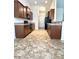 A full kitchen view with appliances, dark cabinets and tiled flooring at 7629 High Maple Cir, North Charleston, SC 29418