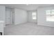 Open bonus room with carpet, neutral paint, large windows and plenty of space for entertaining at 770 Meadowbrook Ln, Summerville, SC 29486