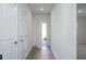 Bright hallway with wood-look floors leading to the entryway and other rooms at 770 Meadowbrook Ln, Summerville, SC 29486