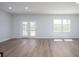 Bright and spacious living room with wood-look floors, natural light, and modern touches at 770 Meadowbrook Ln, Summerville, SC 29486