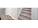 Carpeted staircase with white trim and newel post, connecting the home's levels at 770 Meadowbrook Ln, Summerville, SC 29486