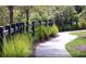 Community walking path with lush landscaping and a wooden fence at 770 Meadowbrook Ln, Summerville, SC 29486