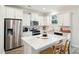 Bright kitchen with stainless steel appliances, white cabinetry, and a marble island with seating at 770 Opal Wing St, Moncks Corner, SC 29461