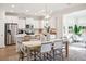 Bright and modern kitchen with white cabinets, stainless steel appliances, and an adjacent dining area at 770 Opal Wing St, Moncks Corner, SC 29461
