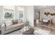Cozy living room with natural light, neutral-toned furniture, and wood-look flooring at 770 Opal Wing St, Moncks Corner, SC 29461