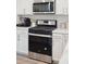 Close-up of a stainless steel gas range and oven with white cabinets at 770 Opal Wing St, Moncks Corner, SC 29461