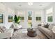 Bright sunroom featuring ample natural light, comfortable seating, and a view of the backyard at 770 Opal Wing St, Moncks Corner, SC 29461