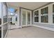 Screened-in patio with concrete flooring and view of the yard and surrounding houses at 772 Opal Wing St, Moncks Corner, SC 29461