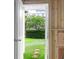View of the backyard from a doorway, showing the grassy yard with a tree in the center at 779 Forrest Dr, Charleston, SC 29492