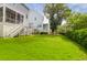 Expansive backyard featuring lush green grass and elegant two-story homes with porches and elevated staircases at 779 Forrest Dr, Charleston, SC 29492