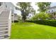 Lush green backyard with healthy grass, steps to home, and an elegant fence line enhancing the property's appeal at 779 Forrest Dr, Charleston, SC 29492