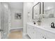 Modern bathroom with white cabinets, dual sinks, and glass-enclosed shower at 779 Forrest Dr, Charleston, SC 29492